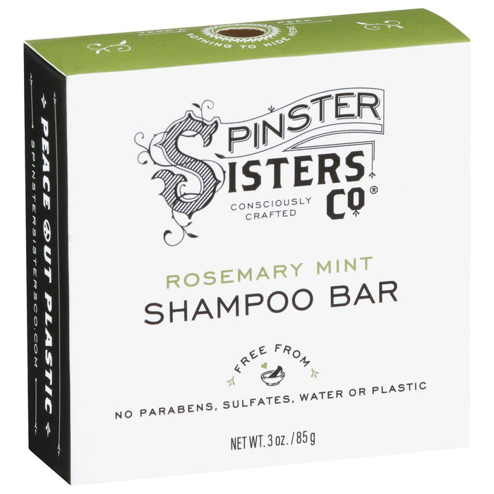 A box of Spinster Sisters Co. Rosemary Mint Shampoo Bar, labeled Consciously Crafted and Free from parabens, sulfates, water or plastic. The box is green and white with decorative text and graphics. Net weight 3 oz.
