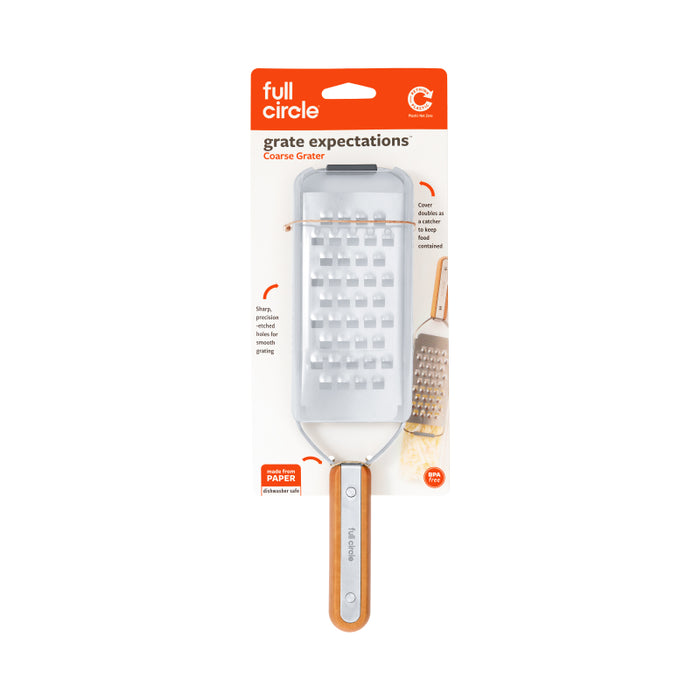 A coarse grater from Full Circle with a stainless steel blade and a bamboo handle, packaged in a white and orange cardboard backing labeled grate expectations.
