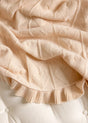 Little Love Baby Blanket - Butter Cream: a luxury cream-colored knit baby blanket featuring a raised heart pattern and a ruffled edge.