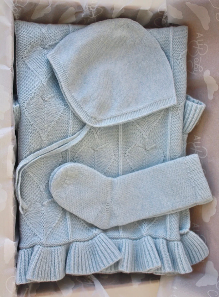 Hydrangea Cashmere Cloud Baby Blanket Gift Set featuring a light blue organic cashmere baby blanket, bonnet, and booties packaged in a gift box.