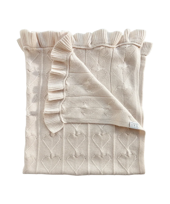 AU Baby Little Love Blanket - Cloud, an off-white organic cashmere baby blanket featuring a heart pattern and ruffled edges.