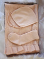 AU Baby Cashmere Cloud Baby Blanket Gift Set - Butter Cream featuring a pale cream organic cashmere blanket with a ruffled edge, a matching bonnet with chin ties, and a single baby sock.