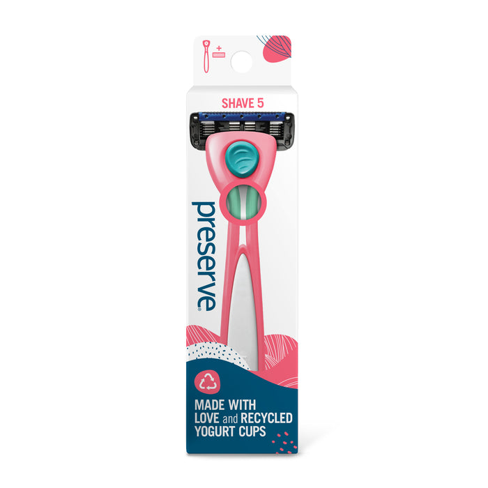 A pink and teal Preserve Shave 5 razor in eco-friendly packaging, labeled Made with love and recycled yogurt cups. The packaging design features blue, pink, and white patterns.