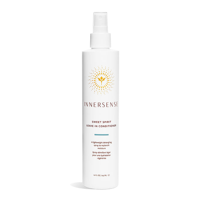 A white bottle of Innersense Organic Beautys Sweet Spirit Leave-In Conditioner, featuring a sunburst logo and a spray nozzle, is infused with Certified Organic plant extracts and elegantly set against a plain white backdrop.