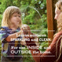 A child and an adult clean a glass window together, smiling at each other. Text on the image promotes Mrs. Meyer’s Glass Cleaner—an ammonia-free solution for sparkling surfaces, perfect for both indoor and outdoor use.