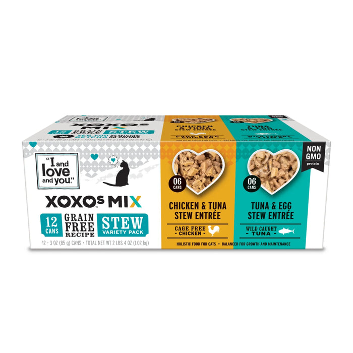 A box of I and love and you XOXOS MIX grain-free stew variety pack cat food, showing 12 cans: 6 Chicken & Tuna Stew Entrée and 6 Tuna & Egg Stew Entrée. The packaging highlights non-GMO and cage-free/wild-caught ingredients.