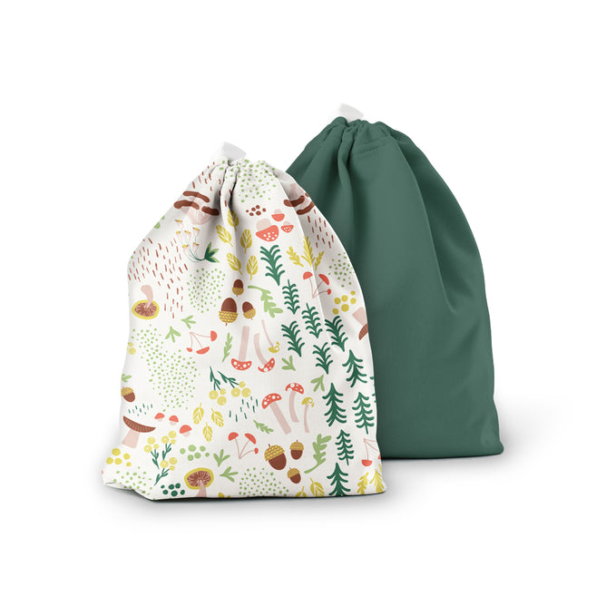The Ditty Bag Duo Wet Bags by Esembly Baby are displayed against a white background. The front bag features colorful illustrations of mushrooms, leaves, and berries, while the back bag is solid forest green. Both bags are crafted from recycled plastic.