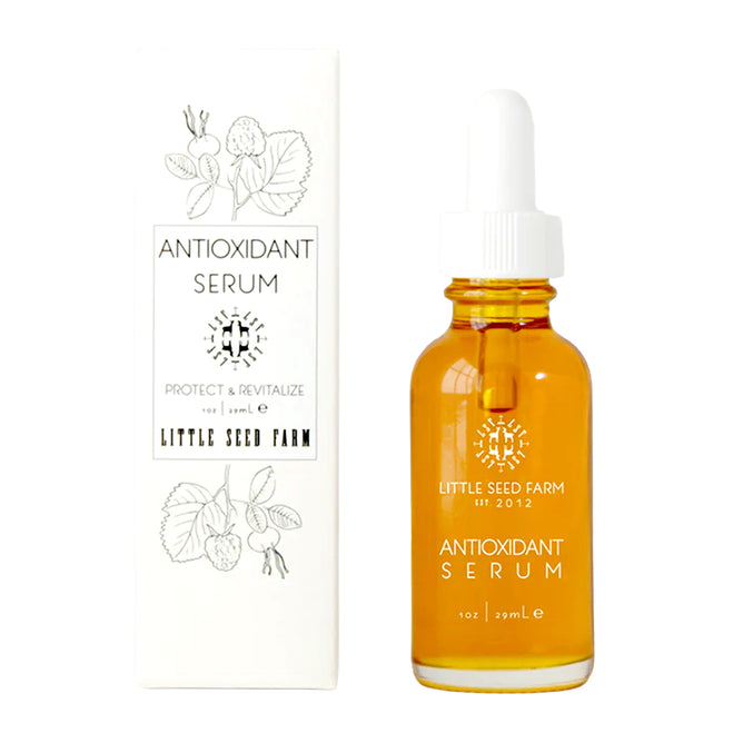 A dropper bottle of Little Seed Farm's Antioxidant Serum - Protect + Revitalize sits beside its white box, which displays botanical illustrations and black product details, emphasizing its nourishing blend of botanical oils.