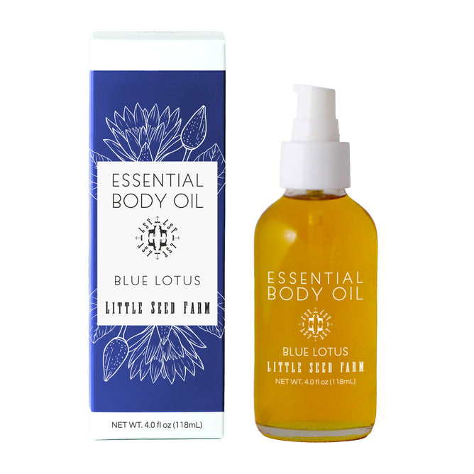 A 4.0 fl oz (118 mL) bottle of Little Seed Farm Body Oils with Blue Lotus scent and a white pump is shown beside its blue and white floral box. This moisturizing oil features organic essential oils.
