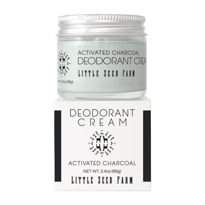 A clear glass jar of Little Seed Farm Deodorant Creams, a natural and aluminum-free deodorant, sits atop its white box packaging with both featuring the brand name and product logo.