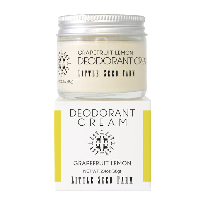 A glass jar of Little Seed Farm Deodorant Creams rests on its yellow and white box, with the brand and product name clearly displayed on both the aluminum-free deodorant jar and packaging.