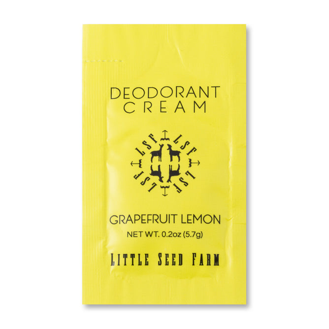 A 0.2 oz (5.7 g) Deodorant Cream Sample—Grapefruit Lemon by Little Seed Farm comes in a yellow packet with their black logo, is aluminum-free, and offers a fresh organic scent.