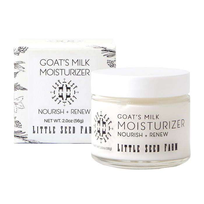 A jar of Little Seed Farm Goat's Milk Moisturizer, ideal for sensitive skin, sits before its white box. Both are labeled “Goat’s Milk Moisturizer,” “Little Seed Farm,” and “Net Wt. 2 oz (56g).”.