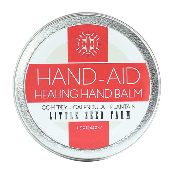 Hand-Aid Healing Hand Balm by Little Seed Farm comes in a 1.5 oz (42g) round tin and is made with organic comfrey, calendula, and plantain to soothe dry, cracked hands.