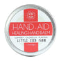 Hand-Aid Healing Hand Balm by Little Seed Farm comes in a 1.5 oz (42g) round tin and is made with organic comfrey, calendula, and plantain to soothe dry, cracked hands.