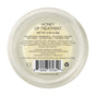 A round container of Little Seed Farm Honey Lip Treatment, a hydrating, plumping lip care with camellia oil. It's GMO-free, gluten-free, paraben-free, and cruelty-free. Ingredients and manufacturer info appear on the back of the lid.
