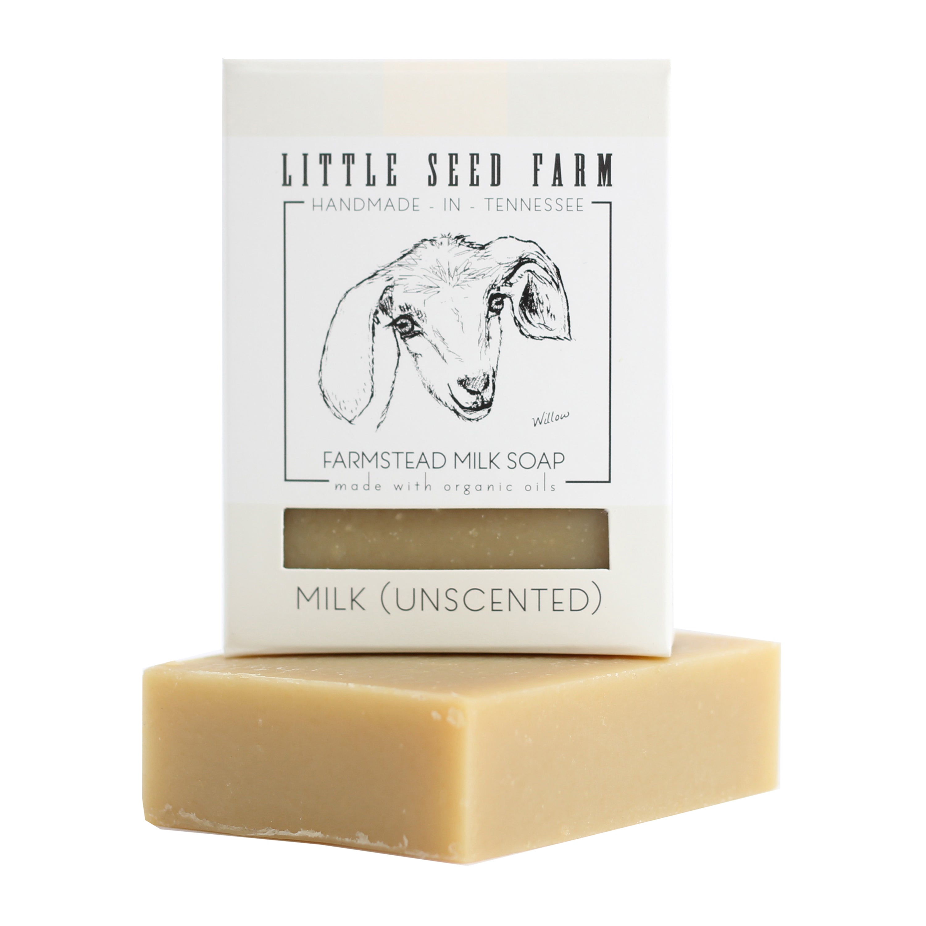 A beige Milk (Unscented) Bar by Little Seed Farm sits before its white box, featuring a black goat head illustration—perfect for sensitive skin.