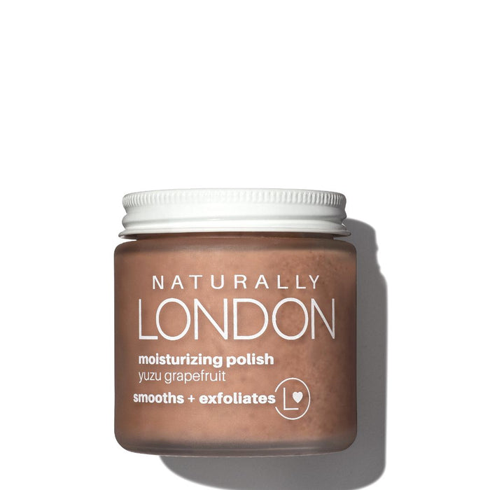 A jar of Naturally London moisturizing polish with yuzu grapefruit, labeled smooths + exfoliates, sits against a white background with a shadow on the right side.