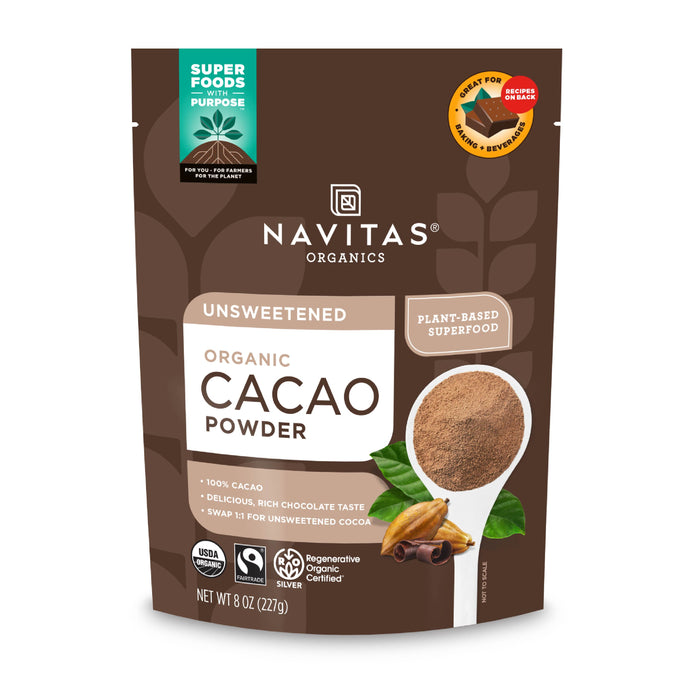 A brown 8oz pouch of Navitas Organics Unsweetened Organic Cacao Powder, featuring a spoonful of cacao powder, cacao beans, and product labels for USDA Organic, Non-GMO, and Regenerative Organic Certified.