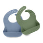The image displays two waterproof silicone bibs by KeaBabies. One is blue, the other green, both featuring adjustable button fastenings and a wide pocket at the bottom to catch food.