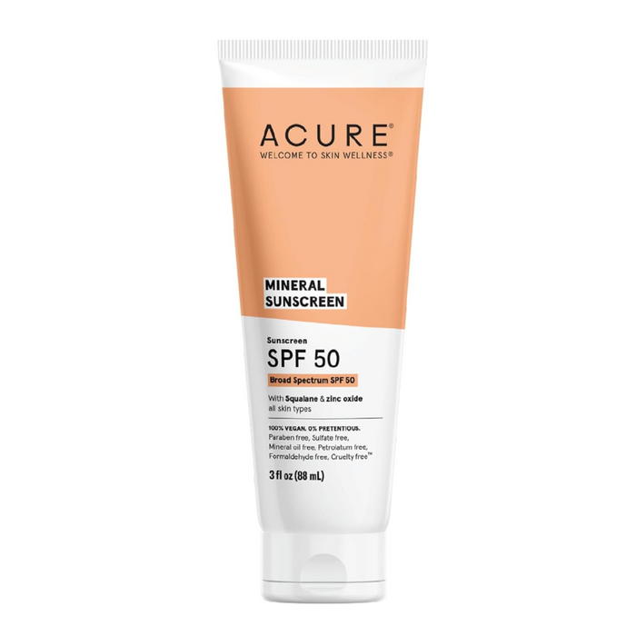 A tube of Acure Mineral Sunscreen SPF 50 with squalane and zinc oxide, 3 fl oz (88 ml), featuring orange and white packaging and labeled as 100% vegan and reef safe.