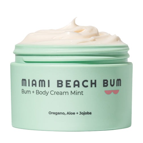A mint-green jar of Miami Beach Bum Bum + Body Cream Mint with a creamy white lotion inside. The label mentions oregano, aloe, and jojoba as ingredients.