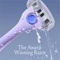Close-up of a purple razor with water cascading over its head, set against a blue background. Text reads 
