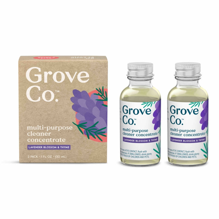 A cardboard box labeled Grove Co. multi-purpose cleaner concentrate stands next to two small glass bottles with the same label and a lavender illustration. The scent is lavender blossom & thyme.