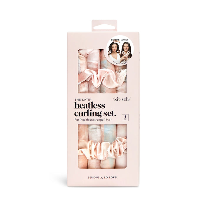 A box of Kitsch Satin Heatless Curling Set for hair, featuring soft pink and beige curling rods and scrunchies, with before-and-after photos demonstrating results on the packaging.