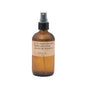 A brown glass spray bottle labeled No. 32: Sandalwood Rose Room & Linen Spray, made by P.F. Candle Co., with a fine mist spray top and natural paper label.