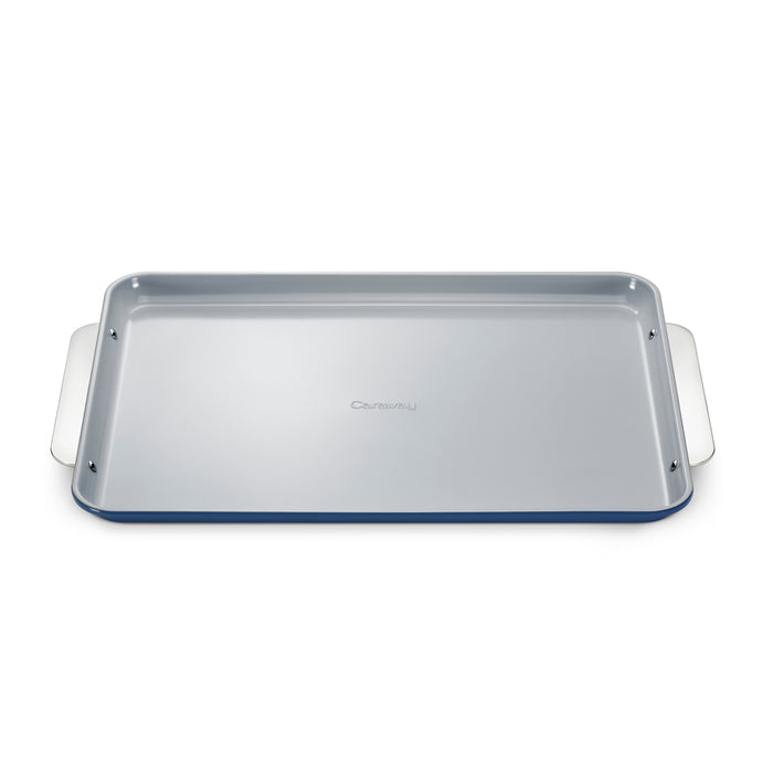 A rectangular metal baking sheet with a light gray nonstick surface, raised edges, and wide handles on both sides is shown against a white background.