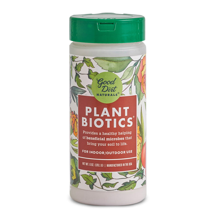 A cylindrical container of Good Dirt Naturals Plant Biotics with a green lid and floral illustration. The label highlights its use for indoor and outdoor plants to add beneficial microbes to soil.