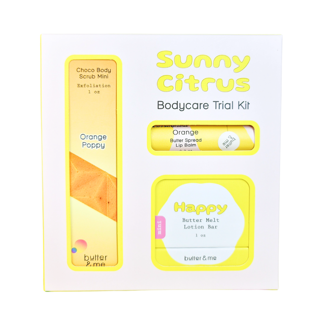 A white and yellow box labeled Sunny Citrus Bodycare Trial Kit contains a Choco Body Scrub Mini, Butter Spread Lip Balm, and Butter Melt Lotion Bar. The packaging features bright, cheerful colors and citrus-themed design.