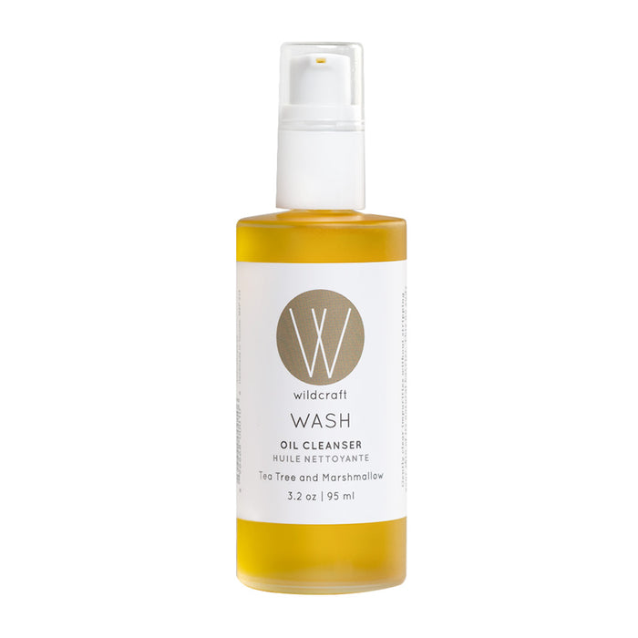 A bottle of Wildcraft Wash Oil Cleanser with a pump dispenser, featuring a gold and white label. The cleanser is tea tree and marshmallow scented and contains 3.2 oz (95 ml) of product.
