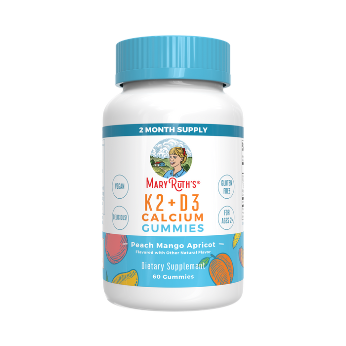 A white bottle of MaryRuth’s K2+D3 Calcium Gummies with a blue cap. The label shows peach mango apricot flavor, vegan, gluten-free, for ages 2+, and contains 60 gummies as a dietary supplement.