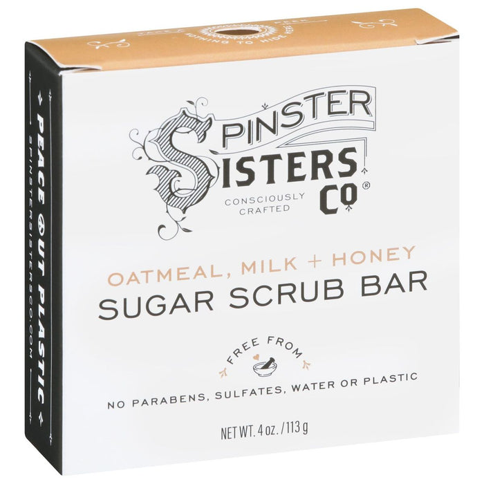 A white box of Spinster Sisters Co. Sugar Scrub Bar in Oatmeal, Milk + Honey scent, labeled as free from parabens, sulfates, water, and plastic. The box is 4 oz (113 g) and features black and gold text.