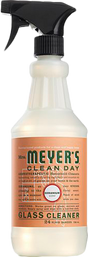 A spray bottle of Mrs. Meyers Glass Cleaner with an ammonia-free formula, black nozzle, and orange label displaying product details and branding.