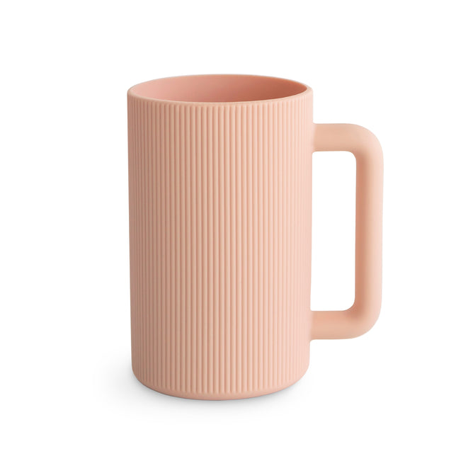 The mushie Bath Rinse Cup features soft silicone, an easy-grip design, and comes in pink—ideal as a stylish bath cup for your baby essentials. Shown against a white background.