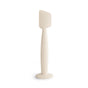 The mushie Diaper Cream Applicator is a white, food-grade silicone tool with a flat, rectangular head and curved handle on a wide base—keeping diaper cream application soft, mess-free, and baby essentials organized.