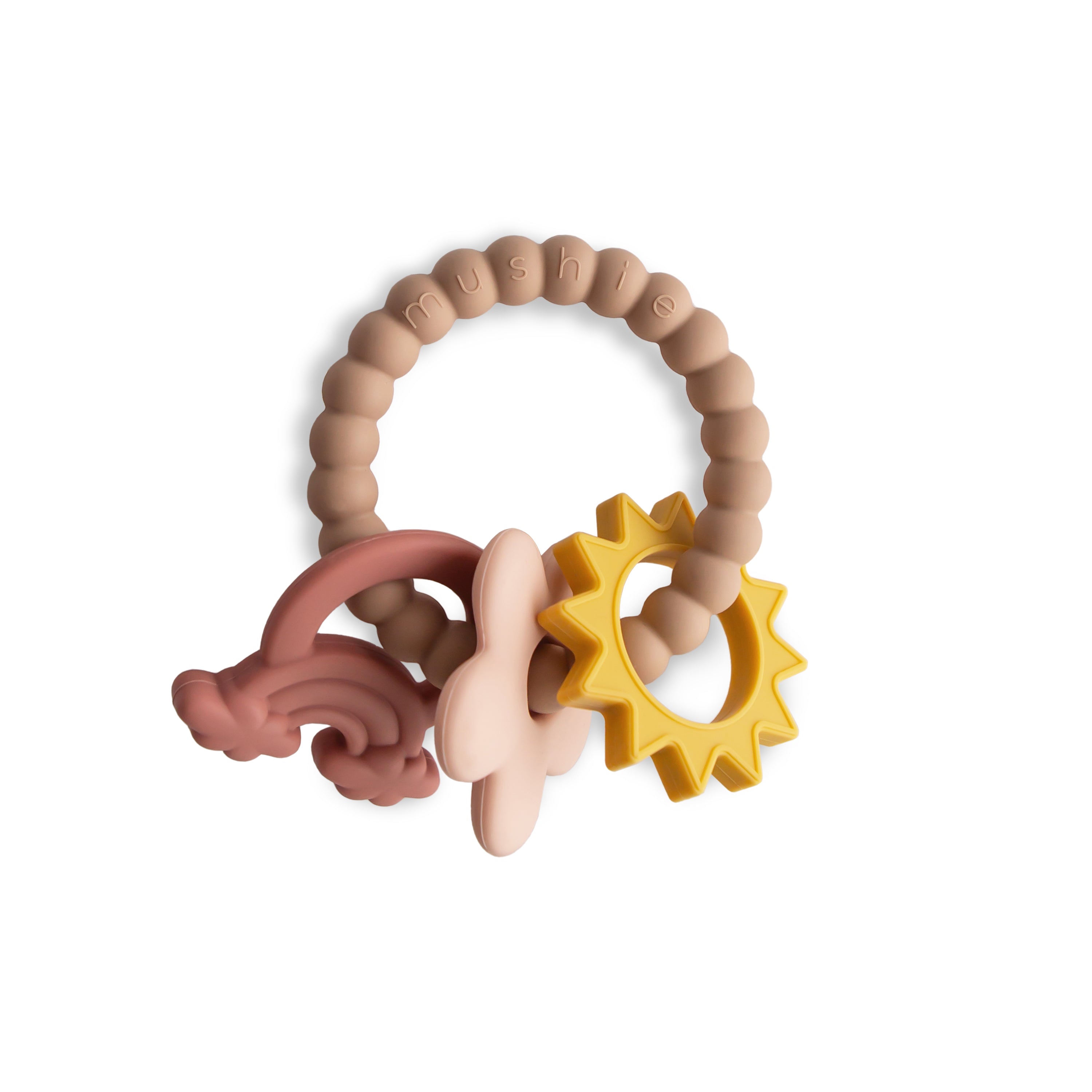 The mushie Nature Teething Ring is made of BPA-free, food-grade silicone, featuring four sensory-textured charms (yellow sun, pink cloud, rust rainbow, beige flower) on a beaded beige ring to soothe teething babies.