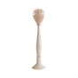 The mushie Silicone Baby Bottle Brush – Dual-Head, Non-Scratch, BPA-Free—shown in beige with an ergonomic handle—stands upright in a matching holder. Its rounded silicone bristles ensure effective cleaning against a white background.