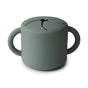 The mushie Silicone Snack Cup – Easy-Grip Handles, BPA-Free is a gray-green food-grade silicone cup with two handles and a flexible, slotted lid for easy snack access and spill prevention—perfect among baby essentials.