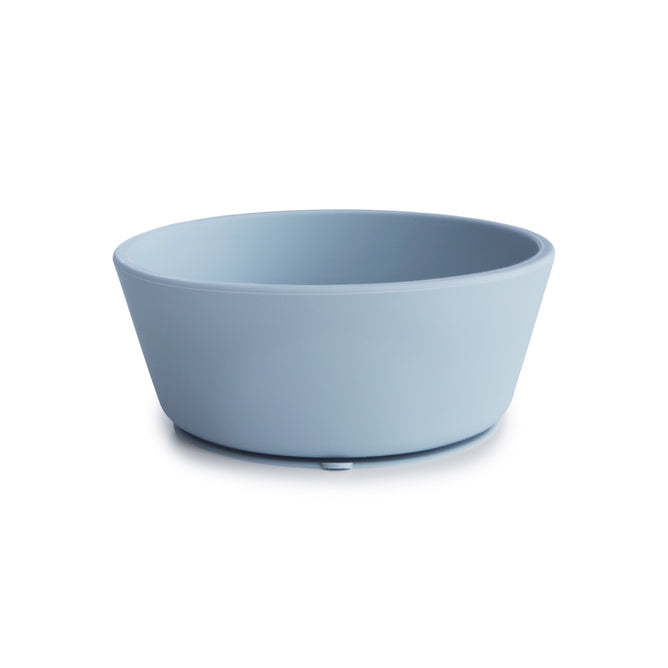 The mushie Silicone Suction Bowl is a plain, light blue, round bowl made from BPA-free, food-grade silicone with smooth sides and a slightly flared rim—safe, non-toxic, and perfect for baby essentials.