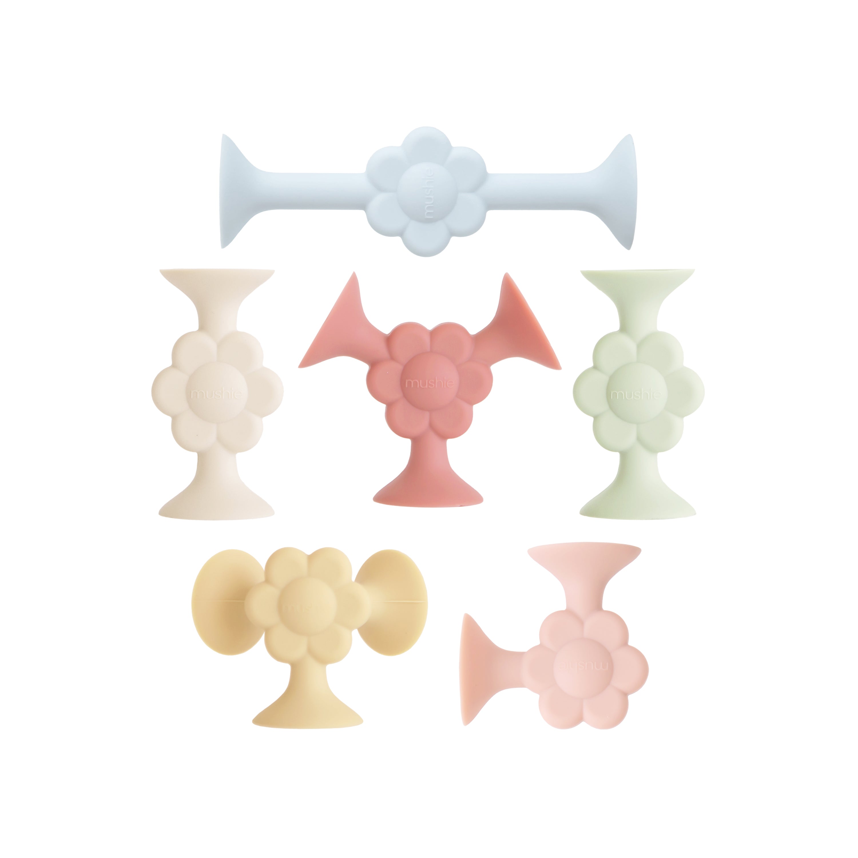 Six mushie Silicone Suction Builders, stackable sensory toys in pastel blue, cream, pink, green, yellow, and coral, are shown on a white background. Made from FDA-tested food-grade silicone and BPA-free.