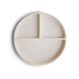 The mushie Silicone Suction Plate is a BPA-free, food-grade cream plate with three compartments—two small and one large—perfect for your baby’s essentials.