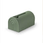 The mushie Bath Spout Cover – Soft Silicone is a green, rainbow-shaped silicone holder with a top slot for wipes or tissues, shown on a white background.