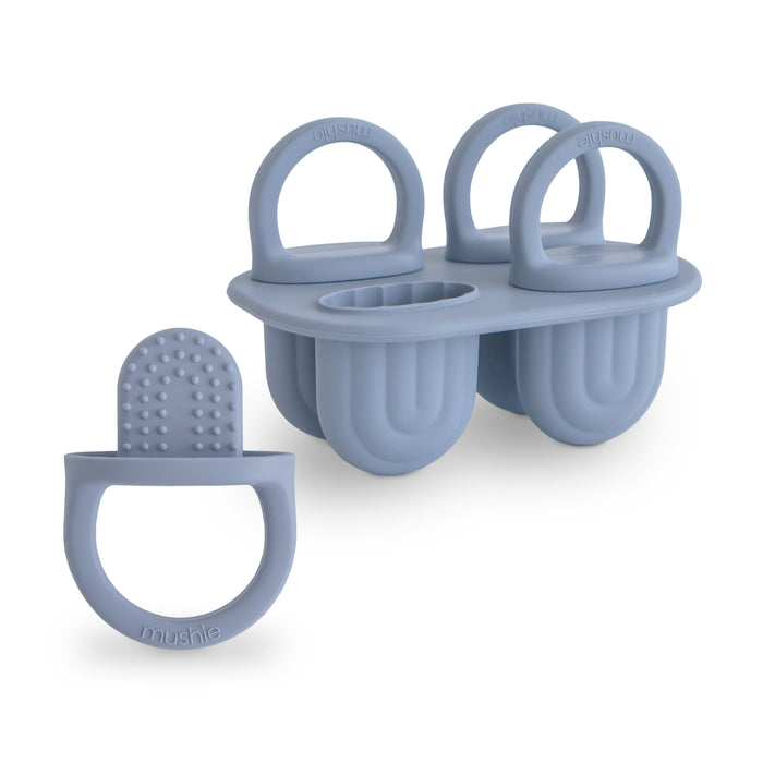 The mushie Toddler Ice Pop Tray features three handle-topped, food-grade silicone molds for easy-release, BPA-free treats, plus a separate textured ring-shaped feeder for healthy snacks.