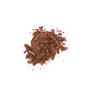 A pile of crushed brown powder makeup, possibly bronzer or eyeshadow, scattered on a white background.