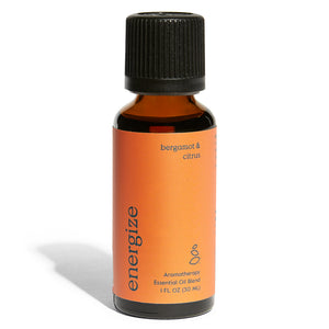 A 1 fl oz amber bottle by Grove Co. labeled in lowercase as energize with a black cap features an orange label saying bergamot & citrus containing an organic essential oil blend for aromatherapy.