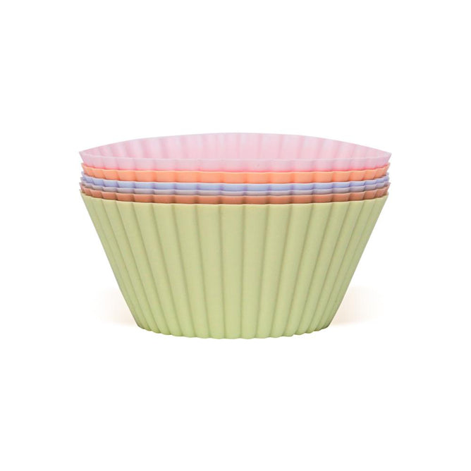 A stack of Silicone Baking Cups by Net Zero Co., featuring fluted, pastel colors with a light green outermost liner, made from BPA-free silicone for safe and flexible baking.